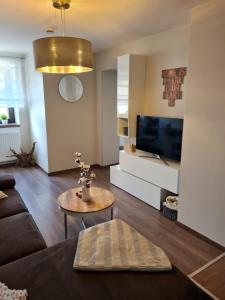 a living room with a couch and a table at Familie Jonas in Schweich