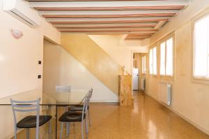 a dining room with a glass table and chairs at Ca' dei Mercanti in Venice