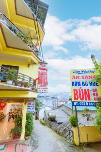 a street with signs on the side of a building at Tạo Phượng Sa Pa Hotel in Sa Pa