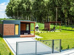 a rendering of a tiny house in a field at Osada Blisko Natury in Gniezno