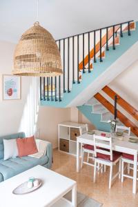 a living room with a table and a staircase at Apartamento AGUADULCE in Sanlúcar de Barrameda