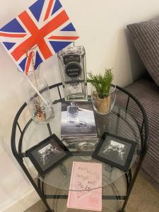 a glass table with a flag on top of it at UNRIVALLED LOCATION FIVE STAR WORCESTER APARTMENT in Worcester