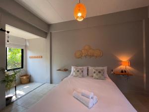 a bedroom with a large bed with towels on it at Home at 9 in Ban Klang (4) +72 photos