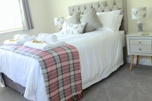 a bedroom with a white bed with two towels on it at The Middlewood - Luxury self contained retreat in Adlington