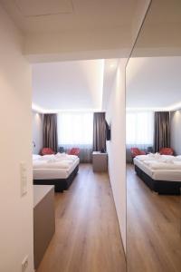 Кровать или кровати в номере PARKHOTEL Krems