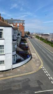 an empty street with buildings on the side of a road at Eastcliffe Penthouse, 2 beds & bathrooms with parking in Cleethorpes