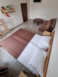 a bedroom with a large bed and a couch at MAFA Hotel in Bukovel