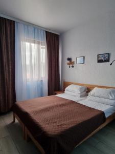 a bedroom with a large bed and a window at MAFA Hotel in Bukovel