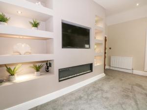 TV a/nebo společenská místnost v ubytování Carriage House