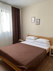 a bedroom with a large bed and a window at MAFA Hotel in Bukovel