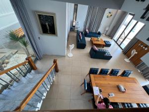 an overhead view of a living room with people sitting on couches at Nancy Grand Vung Tau Villa 5 in Xã Thang Tam