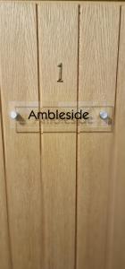 a wooden door with the word ambleside on it at Bonny Brae House by Woodland Park in Windermere