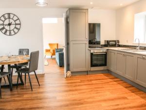 a kitchen with a table and a dining room at Lindens Barn in Shrewsbury