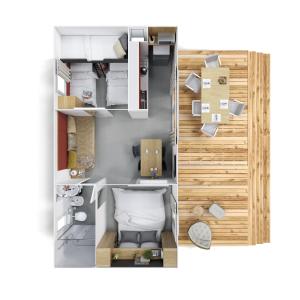 aometric view of a small apartment with a room with a bed at Fischerstüberl in Ossiach