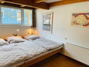 Postel nebo postele na pokoji v ubytování Austernfischer Prerow - Schönes Ferienhaus in Toplage mit großem Garten für Familie und Freunde
