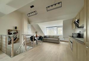 a kitchen and a living room with a table at Charming duplex on the canal Brussels in Brussels