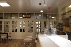 a room with a counter and stools in it at Hotel A Boira in Jaca