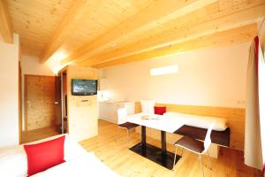 a room with a table and chairs in a room at AlpeLux Appartement an der Skipiste in Jerzens