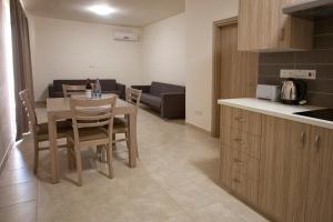 a kitchen and dining room with a table and chairs at Makronisos Village in Ayia Napa