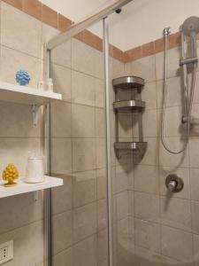 a shower with a glass door and shelves in a bathroom at Hello world- Guest House in Agrigento +15 photos
