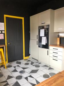 a kitchen with a black and white checkered floor at Suffolk pink house, Newmarket town centre in Newmarket