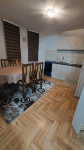 a kitchen with a table and chairs in a room at GuestHouse in Sarajevo