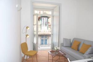 a living room with a couch and a table at Baixa Cosy Apartment in Lisbon