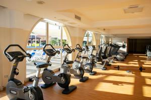 a gym with a row of treadmills and exercise bikes at TUI MAGIC LIFE Calabria - All Inclusive in Pizzo
