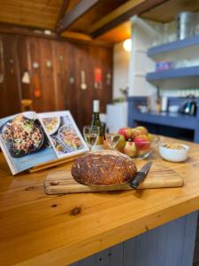 a counter with a loaf of bread on a cutting board at Browns Cottage in Bilpin