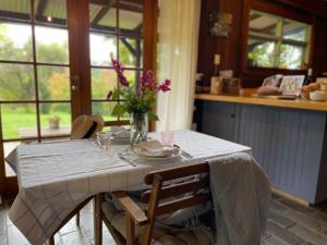 a kitchen with a table with a vase of flowers on it at Browns Cottage in Bilpin