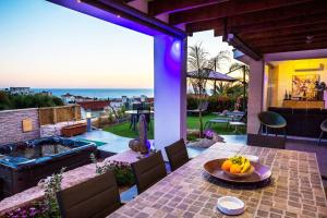 a patio with a table with a bowl of fruit on it at Luxury Marissa Villa in Chlorakas