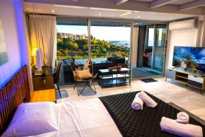 a bedroom with a bed and a living room at Luxury Marissa Villa in Chlorakas