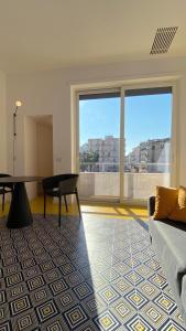 a living room with a couch and a table at Toraldo Suites - Dimore Partenopee in Naples