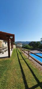 a yard with a fence next to a swimming pool at Quinta de Terreiros 16 Pax - Quinta Inteira in Cabeceiras de Basto