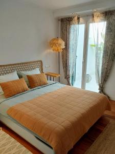 a bedroom with a large bed with a large window at Havana Penthouse in Cala Ratjada