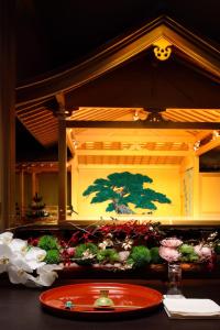 a red plate on a table with flowers on it at Cerulean Tower Tokyu Hotel, A Pan Pacific Partner Hotel in Tokyo