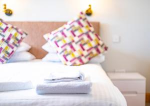 a hotel room with two towels on a bed at The Crown in Callander