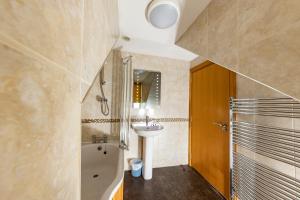 a bathroom with a sink and a toilet and a tub at Crown Hotel in Callander