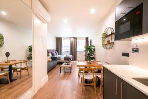 a kitchen and living room with a table and chairs at BILBAO RIVERSIDE by STAYNN APARTMENTS in Bilbao