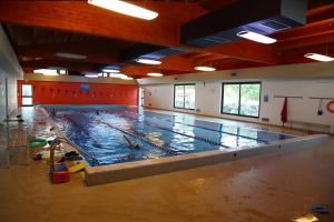 an empty swimming pool in a gym with water on the floor at Agriturismo Monticelli in Mussomeli