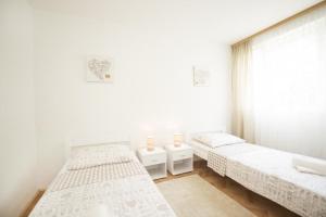 a bedroom with two beds and a window at Apartment Hanna in Split