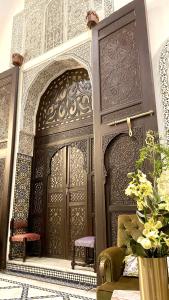 an entrance to a building with a large wooden door at Le Grand Alcazar - Riad in Fez