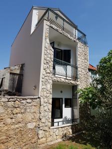a building with a balcony on the side of it at Perlica in Vodice