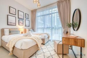 a bedroom with two beds and a mirror and a window at Serene 2BR at Acacia A Dubai Hills Estate By Deluxe Holiday Homes in Dubai