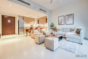 a living room with a couch and chairs and a table at Serene 2BR at Acacia A Dubai Hills Estate By Deluxe Holiday Homes in Dubai
