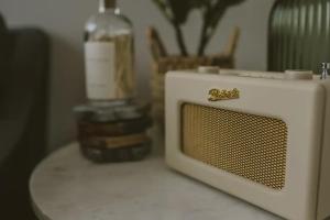 a microwave sitting on a counter with a bottle of alcohol at Water Cabin With Water Sports Equipment and Bikes, Bath in Bristol