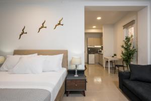 a bedroom with a bed with birds on the wall at Urban Residences Chania in Chania Town