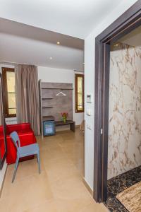 a living room with a red chair and a table at Hotel Repubblica in Milan