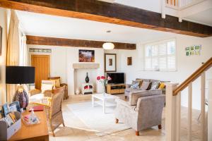 a living room with a couch and a fireplace at Higher Weddicott Barn in Newton Abbot