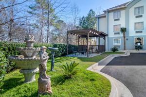 a statue in the grass in front of a house at Comfort Inn & Suites Macon North I-75 in Macon